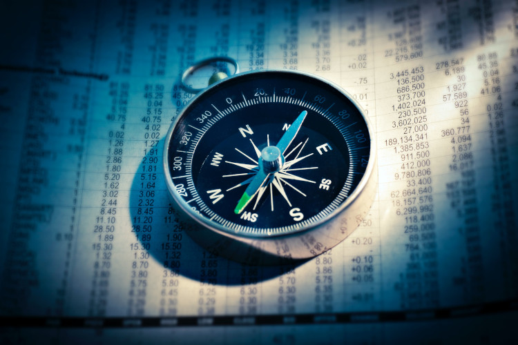 Compass on newspaper stock page