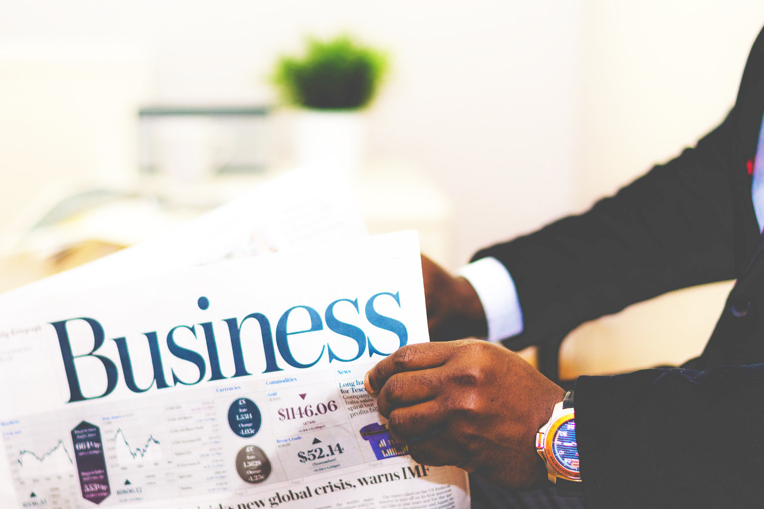 Business man reading business page of newspaper