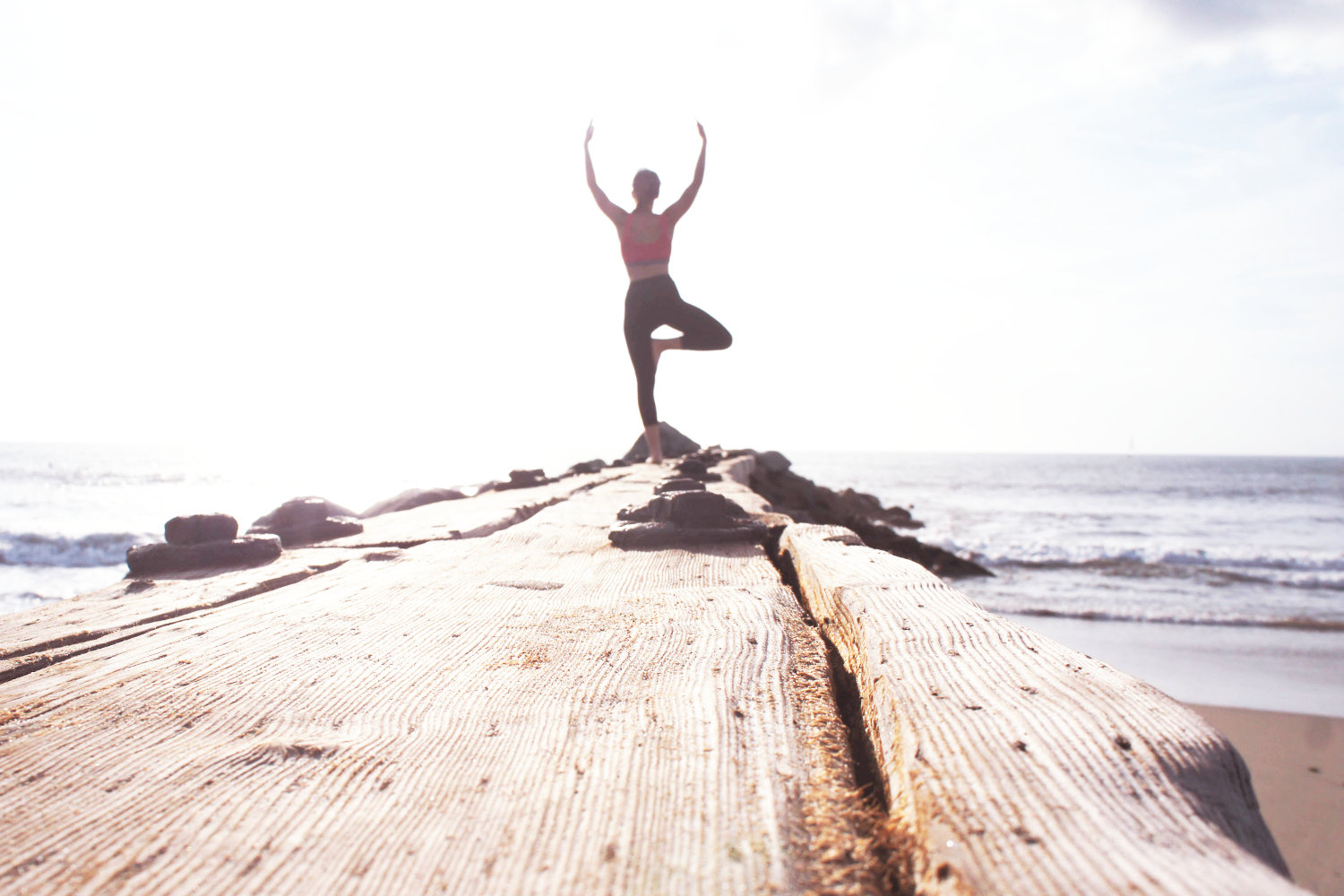Woman doing yoga at beach