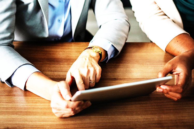 Women going over a financial plan on tablet